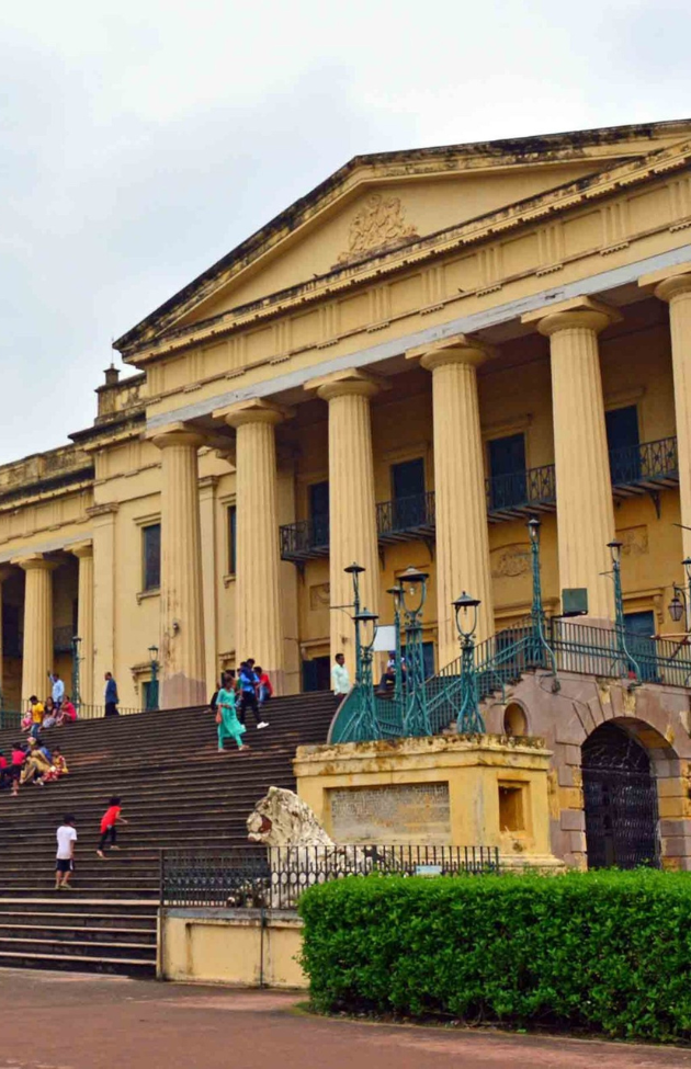 The interiors of Hazarduari Palace showcase chandeliers, arches, and collections from a royal past