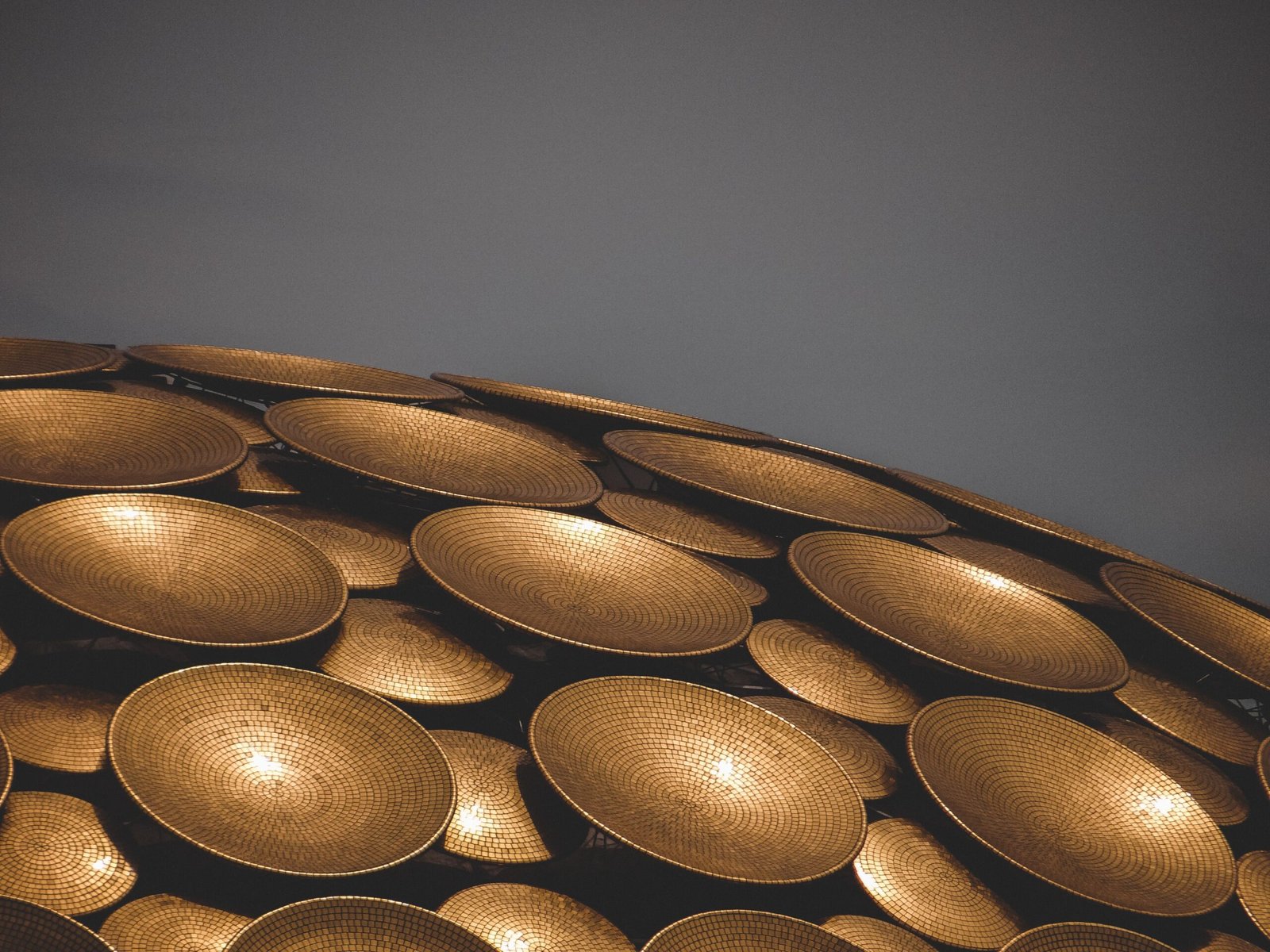 A close-up of the golden discs covering the exterior of the Matrimandir in Auroville, India.