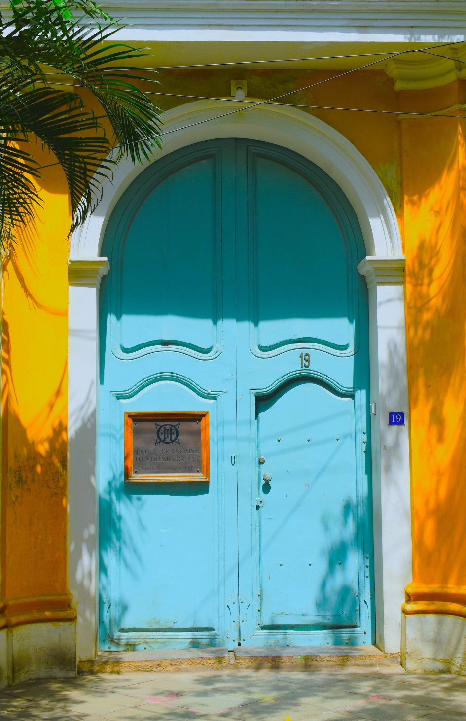 Historic blue arched doorway on a colonial building in the French Quarter of Pondicherry | Maree and Meridian