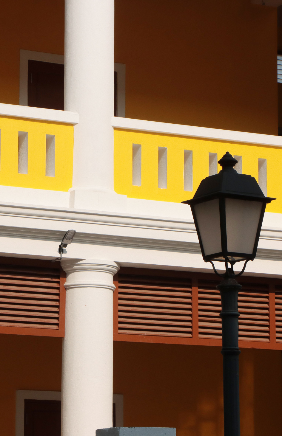 Close-up of a vibrant yellow colonial building in the French Quarter of Pondicherry | Maree and Meridian