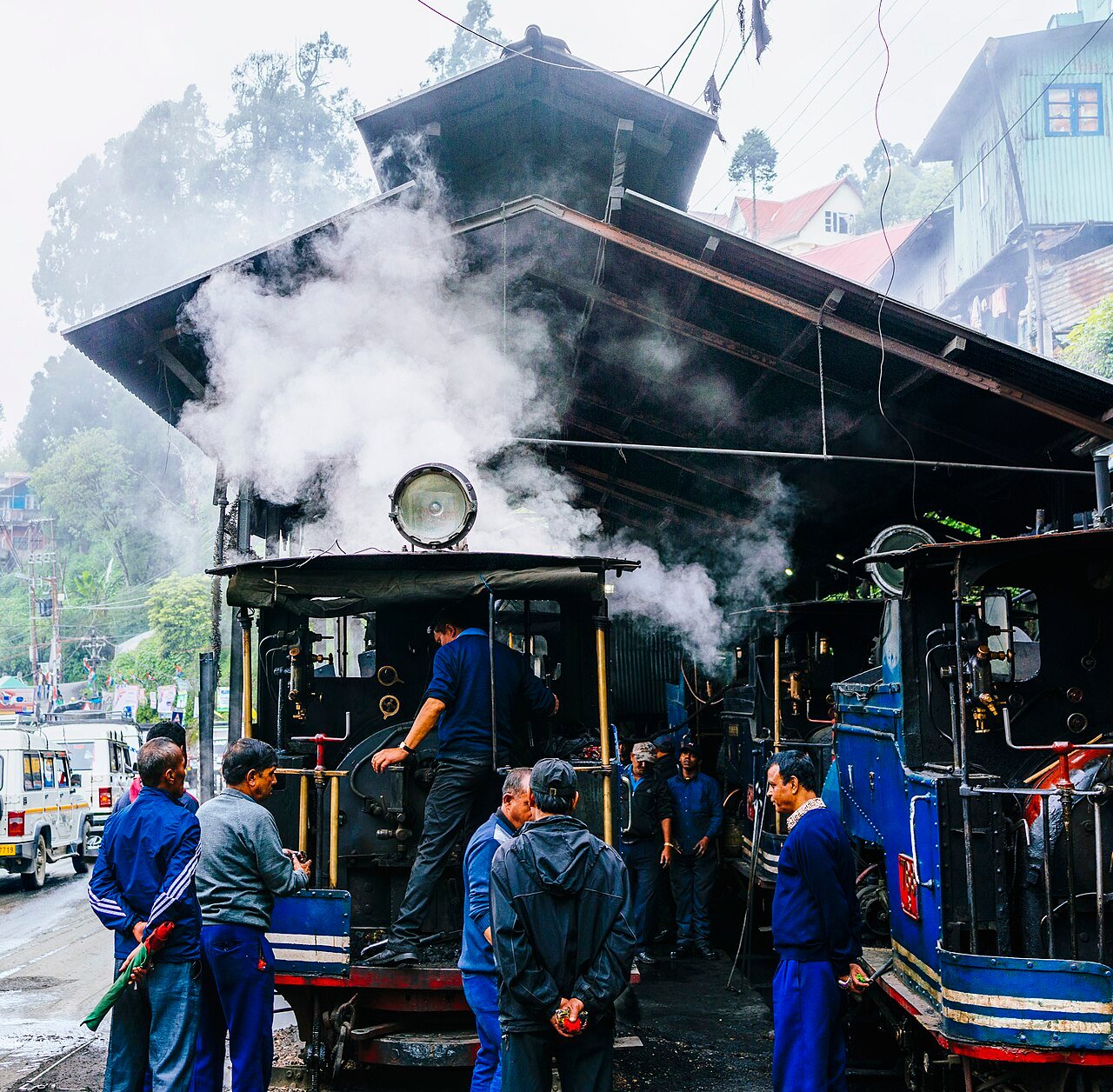Early Darjeeling Toy Train sharing the old hill cart road with bullock carts in the Himalayan foothills