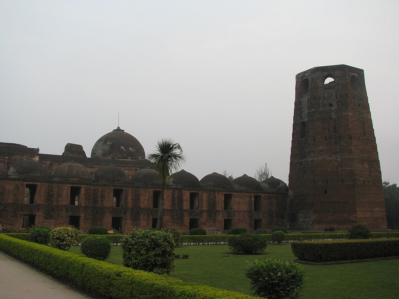 Brick facade and domes of the Katra Mosque in Murshidabad with its tall corner tower
