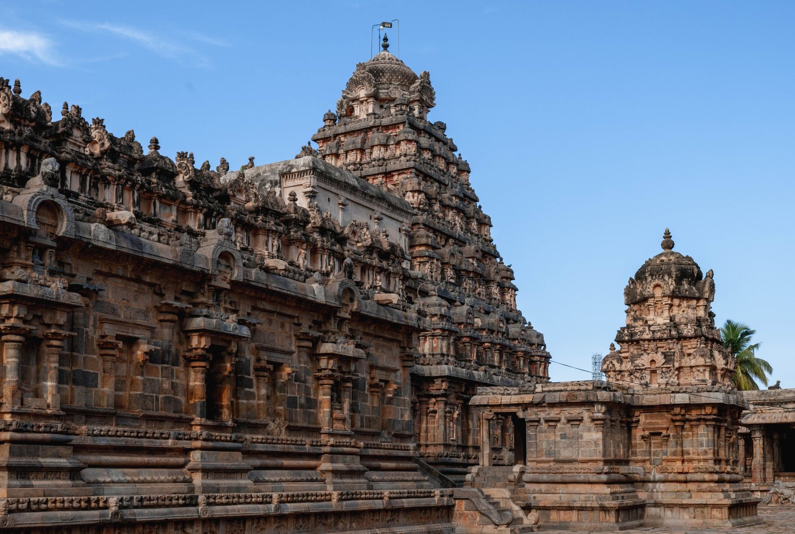 Carved tower over the sanctum of the Airavatesvara Temple at Darasuram under a blue sky